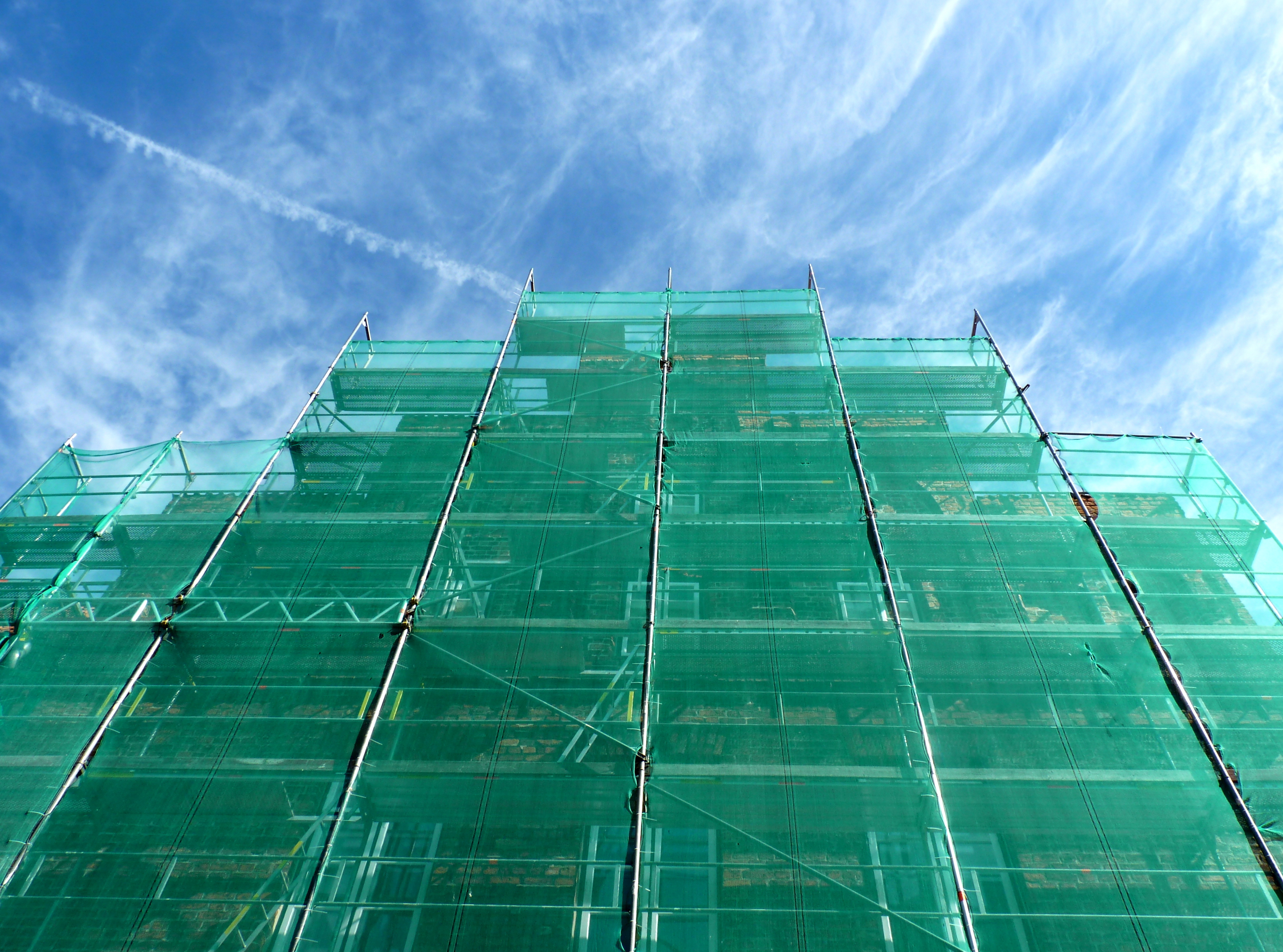 Green construction safety net on scaffolding